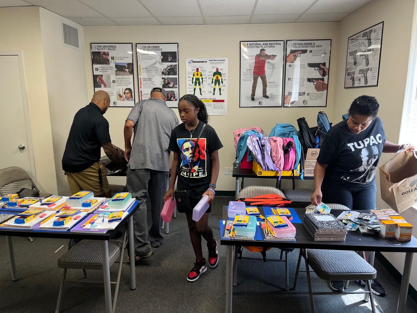 Children receiving school supplies at the Bookbag Drive